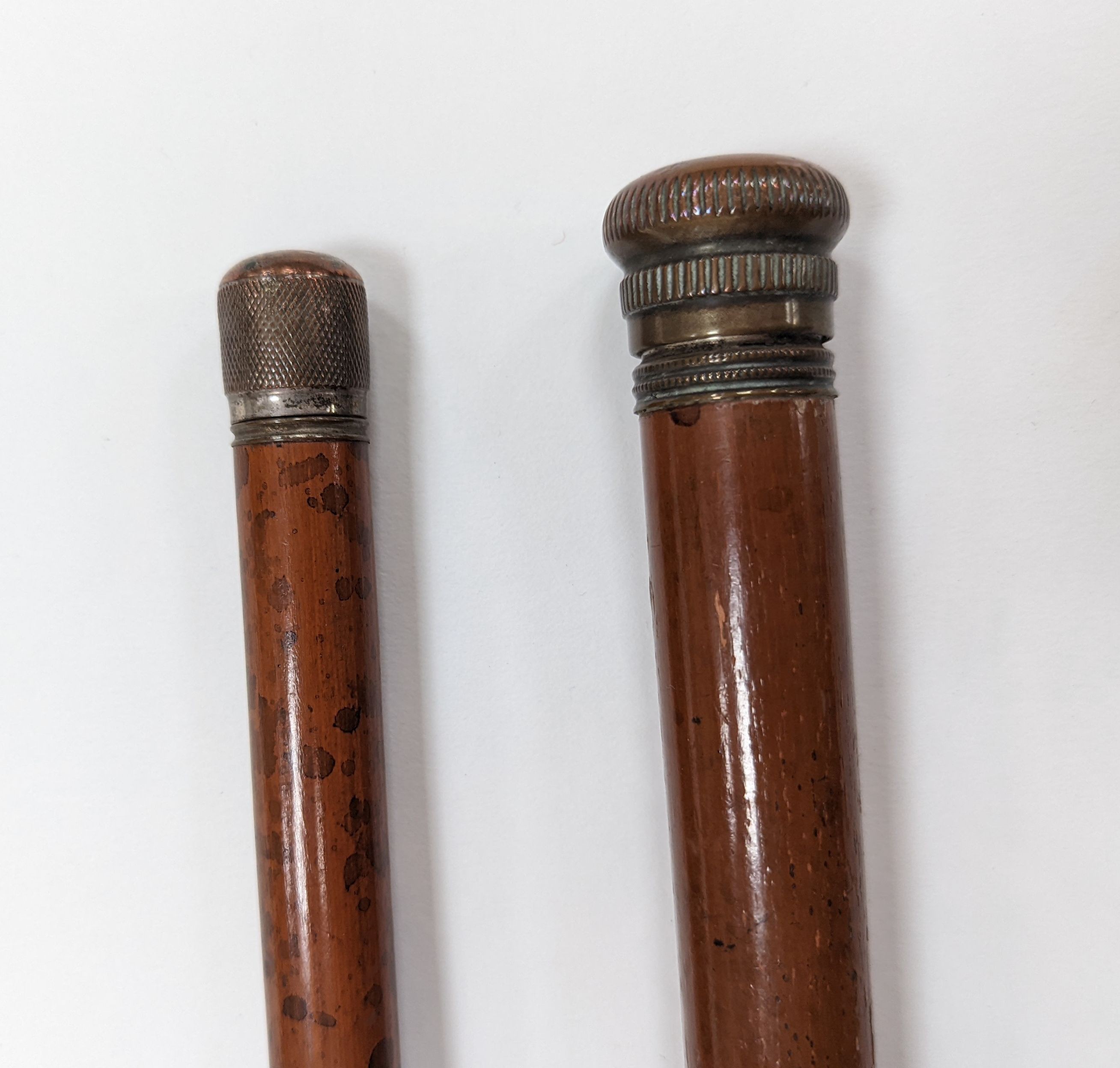 A 19th century novelty ‘pen and pencil’ walking stick together with a glass toddy walking stick